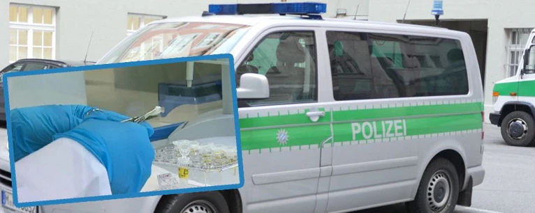 Ein Symbolfoto einer DNA-Probe und ein Polizeifahrzeug im Hintergrund. — © Polizei nimmt Speichelproben in Egmating 