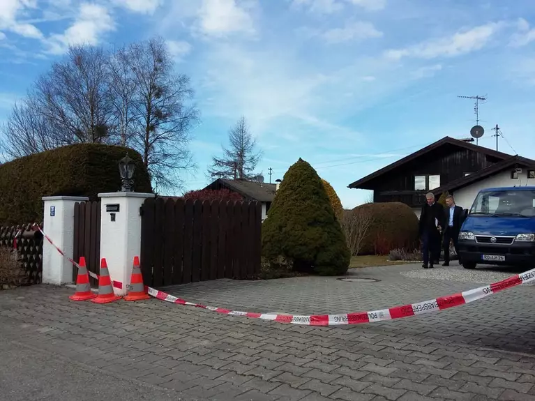 mord haus in königsdorf absperrband mit blauem auto vor dem haus und hohen hecken — © Doppelmord in Königsdorf